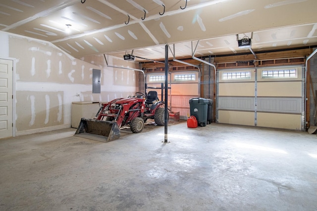 garage with electric panel and a garage door opener