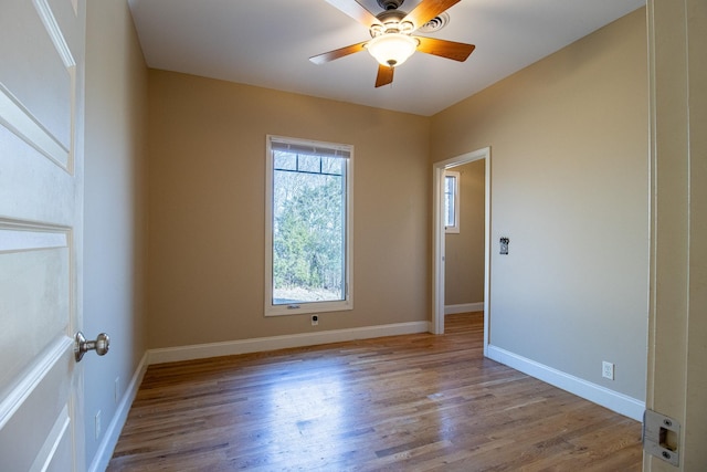 spare room featuring ceiling fan and light hardwood / wood-style flooring