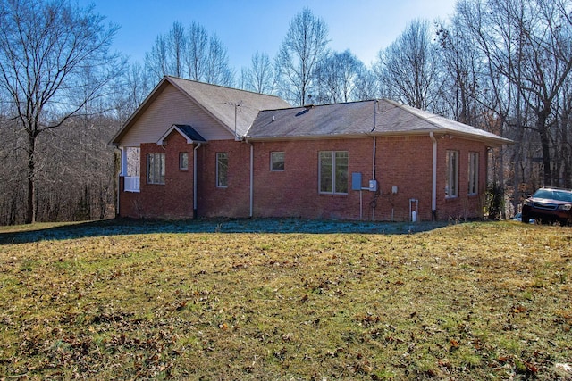 view of side of home featuring a yard