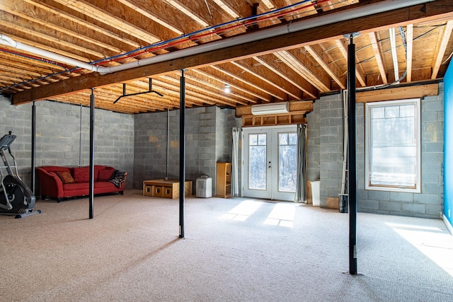 basement featuring french doors, a wall mounted air conditioner, and carpet floors