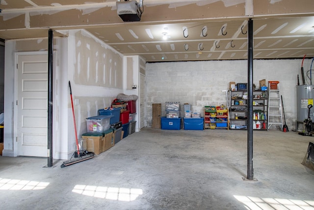 garage featuring water heater and a garage door opener