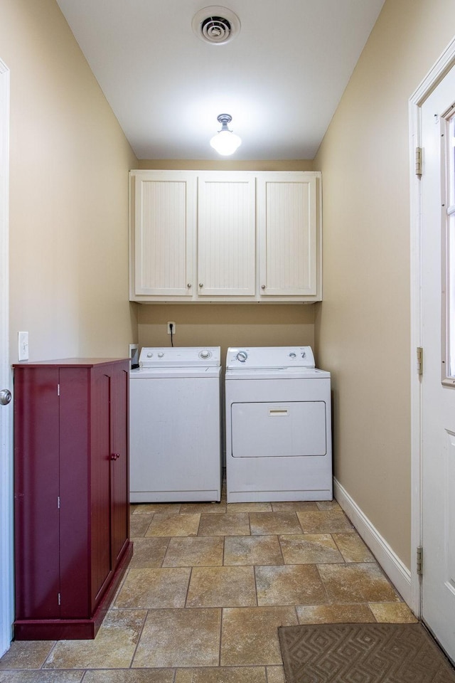 laundry area with cabinets and separate washer and dryer