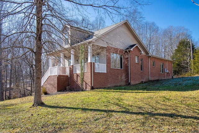 view of side of property with a lawn