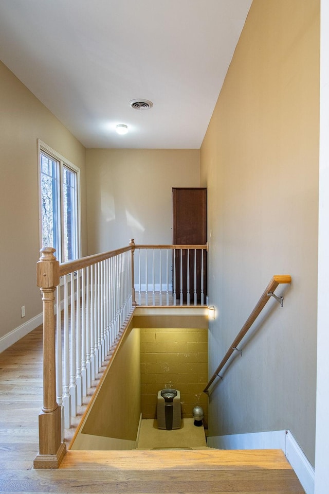 stairs featuring wood-type flooring