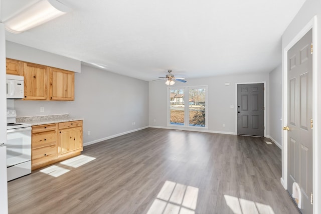 kitchen featuring white appliances, light wood-type flooring, ceiling fan, and light brown cabinets