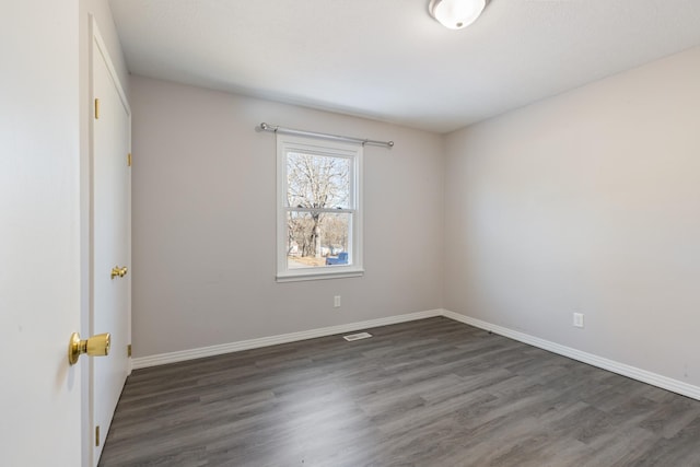 empty room featuring dark hardwood / wood-style flooring