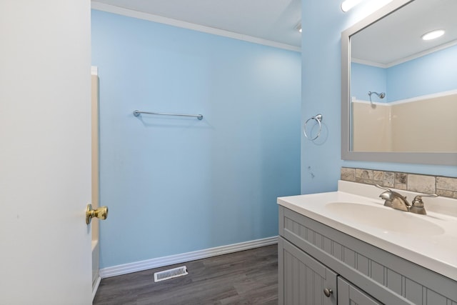 bathroom with shower / bathtub combination, crown molding, vanity, and wood-type flooring