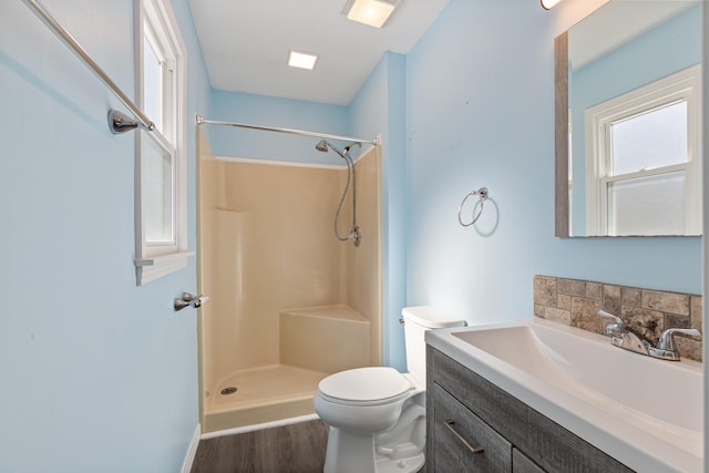 bathroom with walk in shower, toilet, vanity, and wood-type flooring