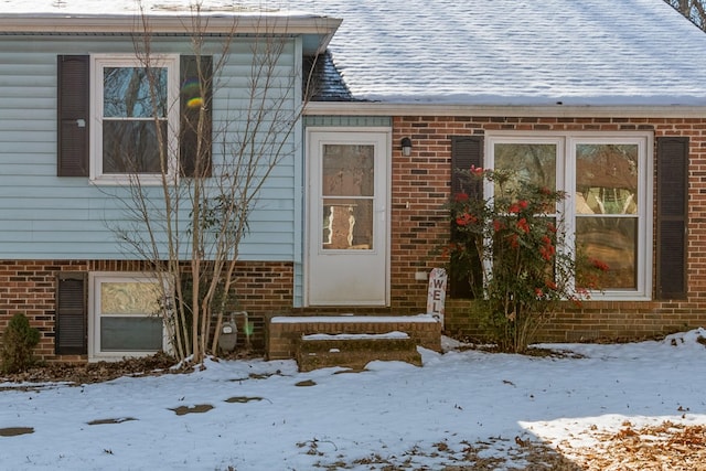 view of snow covered property entrance