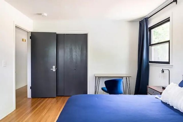 bedroom with a closet and light hardwood / wood-style floors