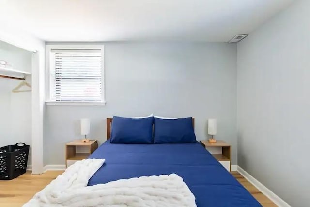 bedroom with wood-type flooring