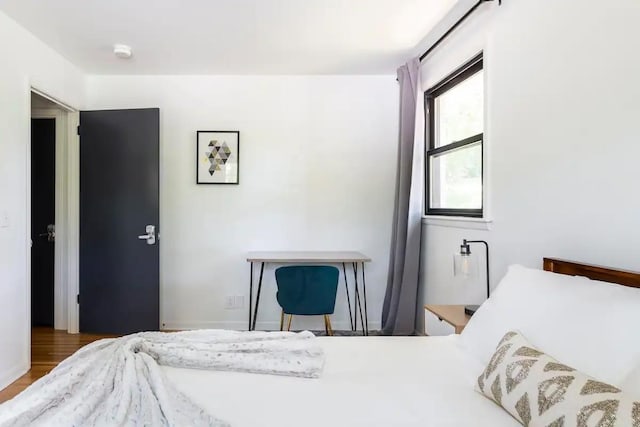 bedroom with hardwood / wood-style floors