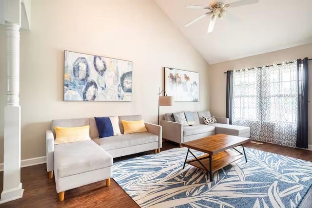 living room featuring ceiling fan, dark wood-type flooring, high vaulted ceiling, and decorative columns