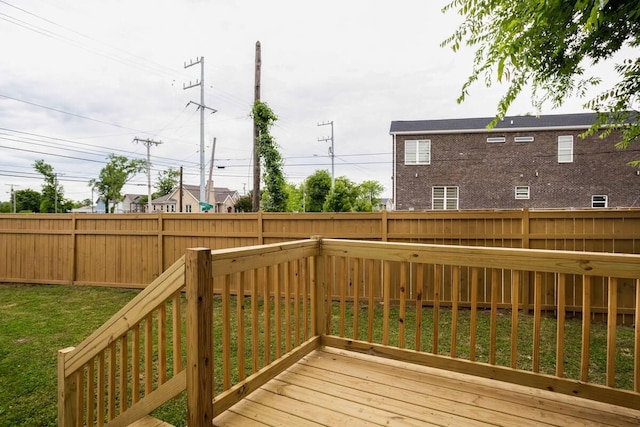 wooden terrace featuring a lawn