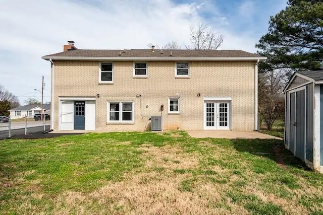 rear view of property featuring a yard, french doors, and cooling unit