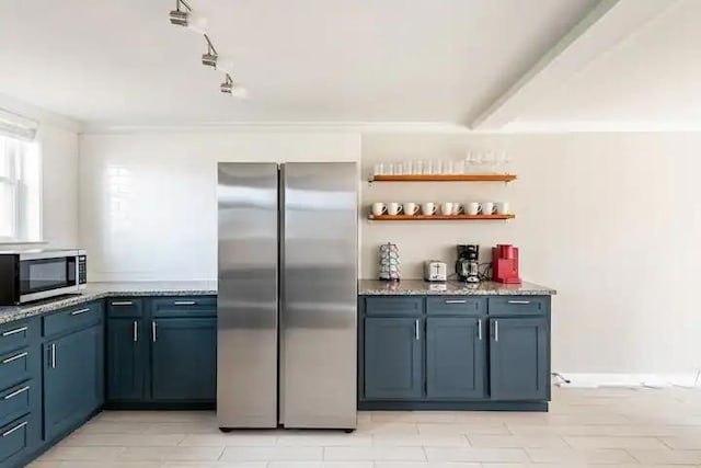 kitchen featuring appliances with stainless steel finishes, blue cabinets, and light stone countertops