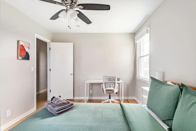 bedroom with ceiling fan and hardwood / wood-style floors