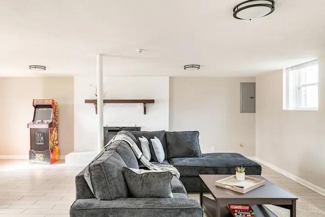 living room featuring electric panel and light hardwood / wood-style flooring