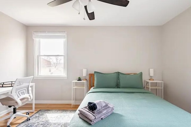 bedroom with hardwood / wood-style flooring and ceiling fan