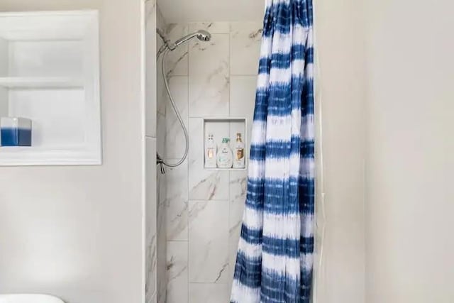 bathroom with toilet and walk in shower