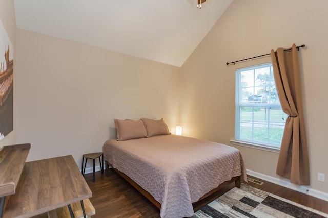 bedroom featuring lofted ceiling and dark hardwood / wood-style flooring