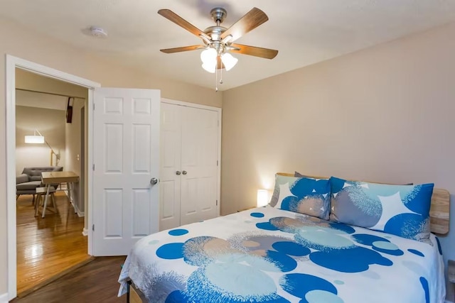 bedroom with ceiling fan, dark hardwood / wood-style flooring, and a closet