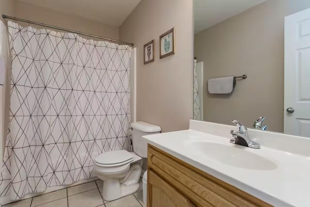 bathroom with toilet, vanity, tile patterned floors, and a shower with curtain