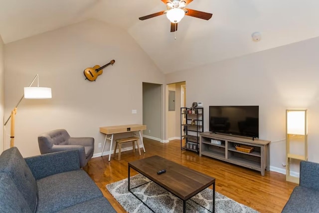 living room featuring ceiling fan, hardwood / wood-style floors, vaulted ceiling, and electric panel