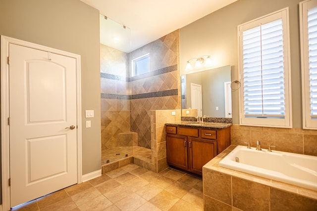 bathroom featuring tile patterned floors, separate shower and tub, a wealth of natural light, and vanity