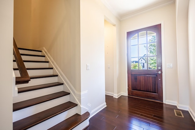 foyer featuring ornamental molding and dark hardwood / wood-style floors