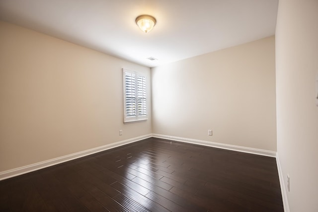 empty room featuring dark wood-type flooring