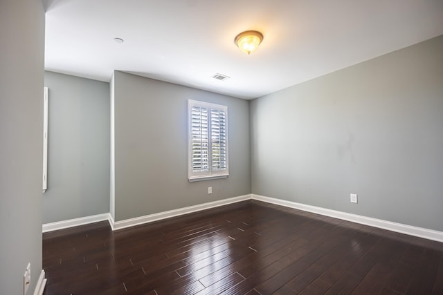 spare room featuring dark hardwood / wood-style floors