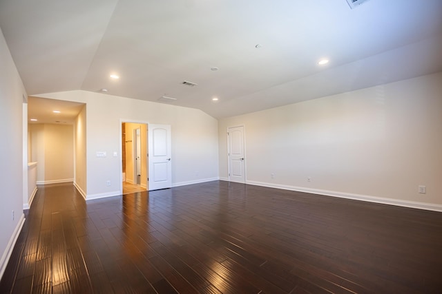 unfurnished room with dark wood-type flooring and vaulted ceiling