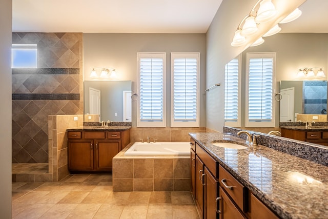 bathroom featuring shower with separate bathtub, tile patterned floors, and vanity