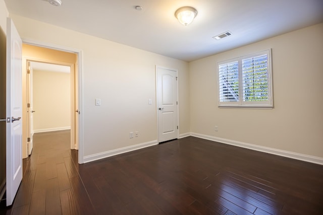 unfurnished bedroom featuring dark hardwood / wood-style flooring