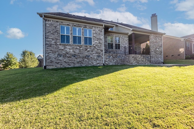 rear view of house with a lawn