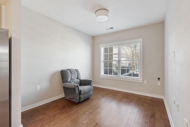 sitting room with wood-type flooring