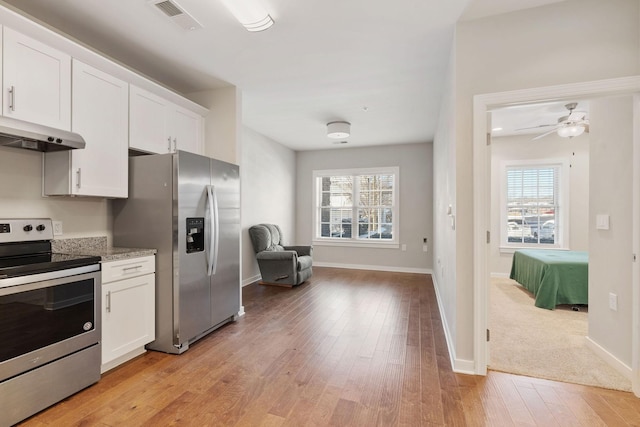 kitchen with white cabinetry, ceiling fan, plenty of natural light, and appliances with stainless steel finishes