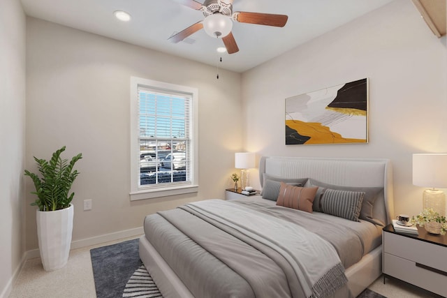 bedroom with ceiling fan and light colored carpet