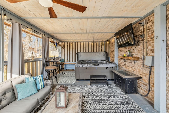 sunroom / solarium featuring ceiling fan and wood ceiling