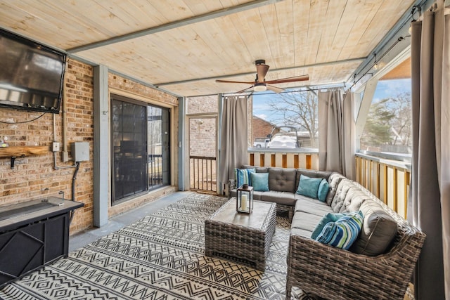 sunroom featuring ceiling fan and wooden ceiling