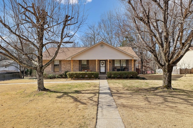 view of front of home with covered porch and a front lawn