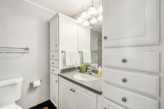 bathroom with toilet, crown molding, and vanity