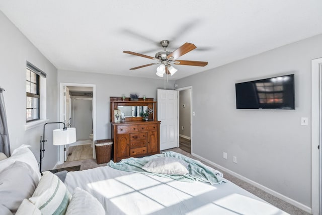 bedroom with a closet, ceiling fan, and a spacious closet