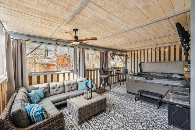 sunroom with ceiling fan and wood ceiling