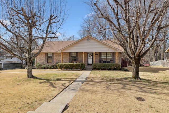 single story home featuring a porch and a front lawn