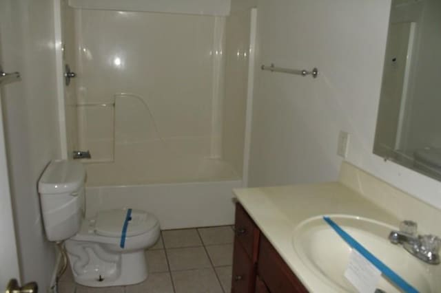 full bathroom featuring toilet, vanity, tile patterned floors, and tub / shower combination