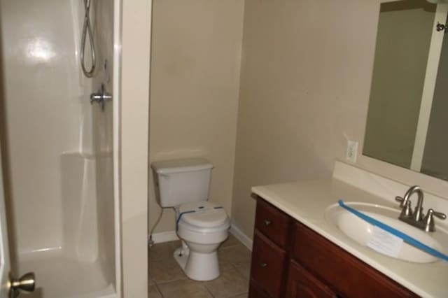 bathroom with toilet, tile patterned flooring, a shower, and vanity