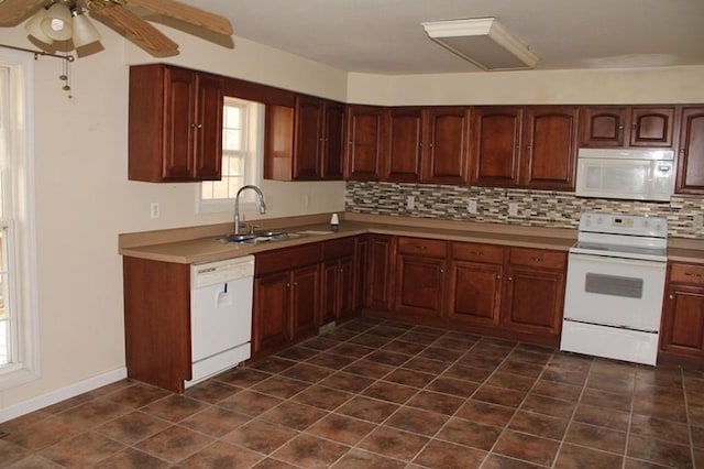 kitchen featuring white appliances, ceiling fan, decorative backsplash, and sink