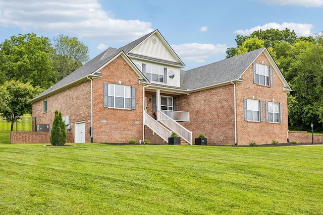 back of house featuring a lawn and a garage